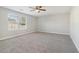 Large bedroom with window, carpet, and ceiling fan at 6897 Estepona St, Atlanta, GA 30349