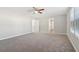 Large bedroom with window, carpet and access to hallway at 6897 Estepona St, Atlanta, GA 30349