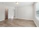 Bedroom with wood-look flooring and access to a closet at 6897 Estepona St, Atlanta, GA 30349