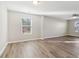 Bright and airy bedroom with wood-look flooring and a large window at 6897 Estepona St, Atlanta, GA 30349