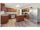 Modern kitchen featuring an island, stainless steel appliances, and wood cabinets at 6897 Estepona St, Atlanta, GA 30349