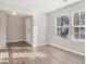 Bright living room with large windows and wood-look floors at 6897 Estepona St, Atlanta, GA 30349