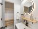 Bathroom with updated vanity, floating shelves, and linen closet at 994 Byron Sw Dr, Atlanta, GA 30310