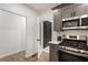 Kitchen features gray cabinets, stainless steel appliances, and a brick accent wall at 994 Byron Sw Dr, Atlanta, GA 30310