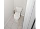 Small powder room with toilet and tile floor at 1025 Campbell Pine Trl, Lawrenceville, GA 30045