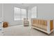 Bright Bedroom features a crib, glider, and ample natural light at 1433 Sugarmill Oaks Ave, Atlanta, GA 30316