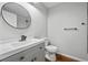 Modern bathroom, gray vanity, and round mirror at 452 Lindsay Nw St, Atlanta, GA 30314