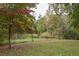 Large backyard with mature trees and pond view at 105 Tranquillity Dr, Villa Rica, GA 30180