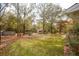 Large backyard featuring outbuildings, mature trees, and a well-maintained lawn at 105 Tranquillity Dr, Villa Rica, GA 30180