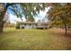 House backyard with deck, trees, and a separate building at 105 Tranquillity Dr, Villa Rica, GA 30180