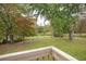 Scenic backyard view of an expansive grassy area and a tranquil pond at 105 Tranquillity Dr, Villa Rica, GA 30180