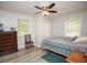 Cozy bedroom featuring a ceiling fan, two windows, and wood-look floors at 105 Tranquillity Dr, Villa Rica, GA 30180