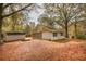 Home exterior with a shed sitting amongst the trees with leaves all around at 105 Tranquillity Dr, Villa Rica, GA 30180