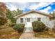 Charming front exterior of the home featuring landscaped bushes, a front door and brick at 105 Tranquillity Dr, Villa Rica, GA 30180