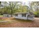 Exterior view of home with a narrow sidewalk and leaves spread throughout yard at 105 Tranquillity Dr, Villa Rica, GA 30180