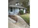 Welcoming front entrance with a sidewalk, lush landscaping and covered porch at 105 Tranquillity Dr, Villa Rica, GA 30180