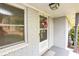 Covered front entrance featuring a white door with a wreath and painted brick exterior at 105 Tranquillity Dr, Villa Rica, GA 30180