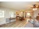 Cozy living room featuring wood floors and ample natural light, open to dining and kitchen at 105 Tranquillity Dr, Villa Rica, GA 30180