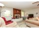 Comfortable living room featuring a fireplace with a brick hearth, plush seating, and natural light at 105 Tranquillity Dr, Villa Rica, GA 30180