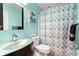 Light blue bathroom with a shower/tub combo and glass sink at 113 Willow Hill Ln, Stockbridge, GA 30281