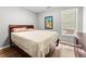 Bedroom with a wooden bed frame, beige bedding and hardwood floors at 113 Willow Hill Ln, Stockbridge, GA 30281