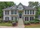 Two-story house with a large front porch and manicured lawn at 113 Willow Hill Ln, Stockbridge, GA 30281