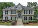 Two-story house with gray siding, black shutters, and a landscaped yard at 113 Willow Hill Ln, Stockbridge, GA 30281