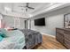 Bright main bedroom with wood floors and a large TV at 113 Willow Hill Ln, Stockbridge, GA 30281