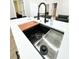 Modern kitchen island with stainless steel sink and a built-in cutting board at 1705 Nw Mary George Ave, Atlanta, GA 30318