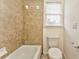 Clean bathroom with a tub and shower, toilet, and tile flooring at 6037 Addington Nw Dr, Acworth, GA 30101