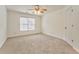 Bright bedroom with ceiling fan, carpet, and large window at 6037 Addington Nw Dr, Acworth, GA 30101