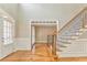 Bright entryway with hardwood floors and elegant staircase at 6037 Addington Nw Dr, Acworth, GA 30101