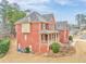 Brick house with front porch, landscaping, and driveway at 6037 Addington Nw Dr, Acworth, GA 30101