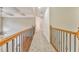 Upstairs hallway with wood railing and carpet at 6037 Addington Nw Dr, Acworth, GA 30101