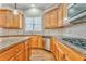 Kitchen with wood cabinets, granite countertops, and stainless steel appliances at 6037 Addington Nw Dr, Acworth, GA 30101