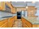 Kitchen boasts wood cabinets, granite countertops, and stainless steel appliances at 6037 Addington Nw Dr, Acworth, GA 30101