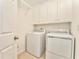 Laundry room with washer, dryer, and cabinets at 6037 Addington Nw Dr, Acworth, GA 30101