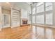 Bright living room with hardwood floors, fireplace, built-in shelves, and high ceilings at 6037 Addington Nw Dr, Acworth, GA 30101