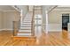 Grand staircase with wrought iron railing and hardwood floors at 6037 Addington Nw Dr, Acworth, GA 30101