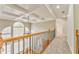 Upstairs hallway with high ceilings, wood railing, and carpet at 6037 Addington Nw Dr, Acworth, GA 30101