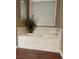 Relaxing bathtub with a window and tile surround at 103 Live Oak Ct, Dallas, GA 30157