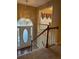 Two-story entryway showcasing a grand staircase and arched window at 103 Live Oak Ct, Dallas, GA 30157