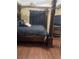 Main bedroom with a large four-poster bed and dark wood furniture at 103 Live Oak Ct, Dallas, GA 30157
