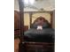 Main bedroom with a large four-poster bed and dark wood furniture at 103 Live Oak Ct, Dallas, GA 30157