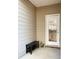 Small back patio with bench and frosted glass door at 1334 Rogers Landing Rd, Lithonia, GA 30058