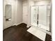Modern bathroom with updated shower and dark hardwood floors at 1334 Rogers Landing Rd, Lithonia, GA 30058