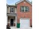 Brick front exterior of townhome with 2-car garage at 1334 Rogers Landing Rd, Lithonia, GA 30058
