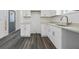 Modern kitchen features white cabinets and dark gray floors at 550 Paines Nw Ave, Atlanta, GA 30318