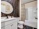 Modern bathroom with a shower/tub combo and geometric wallpaper at 1087 Shadow Glen Dr, Fairburn, GA 30213