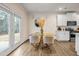 Bright dining area with glass table, modern chairs, and access to backyard at 1087 Shadow Glen Dr, Fairburn, GA 30213